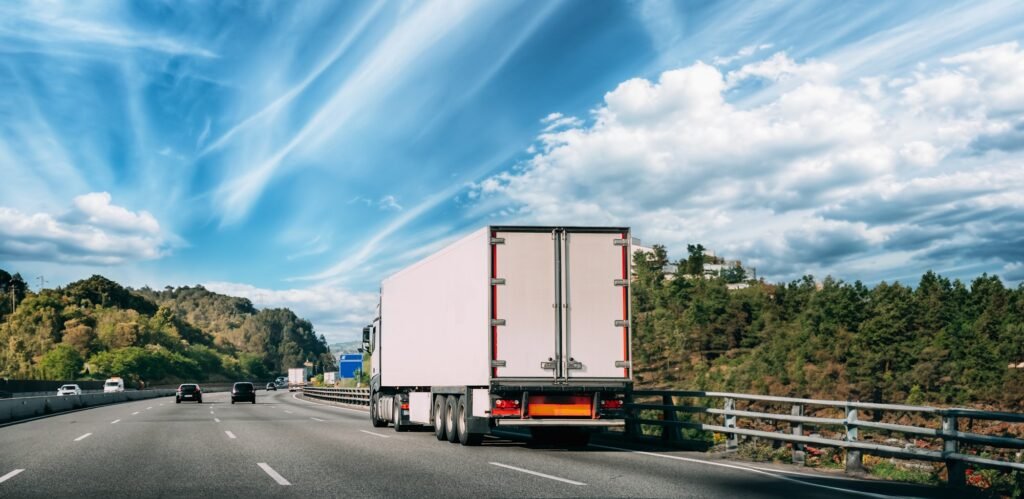 Truck Or Traction Unit In Motion On Road, Freeway. Asphalt Motorway Highway Against Background Of